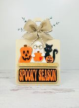 Load image into Gallery viewer, Decorative interchangeable sign with a pumpkin, ghost and black cat on a wooden bread board